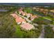 An aerial view of a community featuring a golf course and water views at 9460 Discovery Ter # 202D, Bradenton, FL 34212