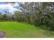 Scenic view of expansive green space with mature trees providing shade and tranquility at 9460 Discovery Ter # 202D, Bradenton, FL 34212