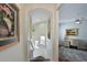 Hallway leading to a flex space or bedroom, with a view of the staircase and stylish decor at 9460 Discovery Ter # 202D, Bradenton, FL 34212