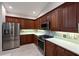 Well-equipped kitchen with stainless steel appliances, granite countertops, and custom backsplash at 9460 Discovery Ter # 202D, Bradenton, FL 34212
