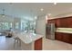 Open kitchen layout with modern appliances, breakfast bar, and tile flooring at 9460 Discovery Ter # 202D, Bradenton, FL 34212