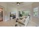 Bright living room featuring tile floors, comfortable seating, and access to balcony at 9460 Discovery Ter # 202D, Bradenton, FL 34212