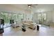 Spacious living room showcasing natural light, tile floors, and access to a large balcony at 9460 Discovery Ter # 202D, Bradenton, FL 34212