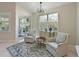 Cozy sitting area with natural light and two patterned chairs, near a sliding glass door at 9460 Discovery Ter # 202D, Bradenton, FL 34212