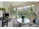 Inviting outdoor patio featuring comfortable seating, ceiling fan, lighting, and serene views at 9460 Discovery Ter # 202D, Bradenton, FL 34212