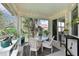 This screened patio offers a peaceful retreat with a table, chairs, and serene views at 9460 Discovery Ter # 202D, Bradenton, FL 34212