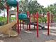 Community playground with slides, climbing structures, and a soft surface for safety at 9460 Discovery Ter # 202D, Bradenton, FL 34212