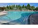 Inviting community pool with step entry, clear blue water, and well-maintained poolside area at 9460 Discovery Ter # 202D, Bradenton, FL 34212