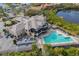 Aerial view of the community pool with lounge chairs and manicured landscaping at 9460 Discovery Ter # 202D, Bradenton, FL 34212