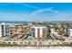 Breathtaking aerial view showcasing community buildings, lush greenery, and shimmering waterfronts at 101 Benjamin Franklin Dr # 63, Sarasota, FL 34236