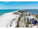 Stunning aerial perspective featuring beachfront condos along a pristine coastline and winding roads at 101 Benjamin Franklin Dr # 63, Sarasota, FL 34236