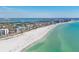 Sweeping aerial view showcases the beautiful coastline and beachfront of this coastal community at 101 Benjamin Franklin Dr # 63, Sarasota, FL 34236