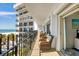 Balcony featuring chairs, a railing, and panoramic ocean views enhancing the condo's serene beachside appeal at 101 Benjamin Franklin Dr # 63, Sarasota, FL 34236