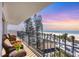 Condo balcony with seating offers a stunning view of the beach and ocean at 101 Benjamin Franklin Dr # 63, Sarasota, FL 34236