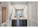 Bathroom featuring dark cabinets, lots of light, and views to the ocean at 101 Benjamin Franklin Dr # 63, Sarasota, FL 34236