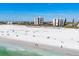Captivating beach view with pristine sands and towering buildings, offering a blend of luxury and nature at 101 Benjamin Franklin Dr # 63, Sarasota, FL 34236