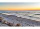 Tranquil beach with calm ocean and a peaceful sky at sunset at 101 Benjamin Franklin Dr # 63, Sarasota, FL 34236