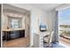 Bedroom area with desk and chair, window with view, and ensuite bathroom at 101 Benjamin Franklin Dr # 63, Sarasota, FL 34236