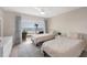 Bedroom features twin beds, a dresser, and a sliding glass door to the balcony with ocean views at 101 Benjamin Franklin Dr # 63, Sarasota, FL 34236