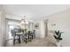 Dining room with tile floors, chandelier, and view to the living room and ocean at 101 Benjamin Franklin Dr # 63, Sarasota, FL 34236