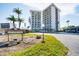 Exterior of the building with lush landscaping and signage out front at 101 Benjamin Franklin Dr # 63, Sarasota, FL 34236