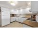 Efficient kitchen featuring white cabinetry, countertops, and modern appliances at 101 Benjamin Franklin Dr # 63, Sarasota, FL 34236