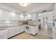 Well-maintained kitchen with white cabinets, appliances, and ample counter space at 101 Benjamin Franklin Dr # 63, Sarasota, FL 34236