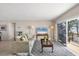 Cozy living room featuring stylish furniture, lamps, and a sliding glass door to the balcony at 101 Benjamin Franklin Dr # 63, Sarasota, FL 34236