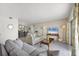 Bright living room featuring a comfortable sofa, TV, and access to a dining area at 101 Benjamin Franklin Dr # 63, Sarasota, FL 34236