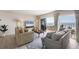 Living room with a large slider opening to the balcony and beach views at 101 Benjamin Franklin Dr # 63, Sarasota, FL 34236