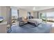 Comfortable main bedroom featuring a king-size bed, ocean view, and seating area at 101 Benjamin Franklin Dr # 63, Sarasota, FL 34236