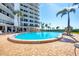 Beautiful outdoor pool area with lounge chairs and palm trees providing a resort-like feel at 101 Benjamin Franklin Dr # 63, Sarasota, FL 34236