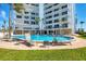 A serene pool with lounge chairs and nearby grassy area offers a tranquil outdoor experience at 101 Benjamin Franklin Dr # 63, Sarasota, FL 34236
