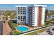 Scenic view of the community pool surrounded by lush greenery and well-maintained landscaping at 101 Benjamin Franklin Dr # 63, Sarasota, FL 34236