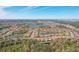 Panoramic aerial view of an expansive residential community with numerous homes encircling serene lakes and lush green landscapes at 10802 Seasons Way, Palmetto, FL 34221