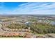Wide aerial view of a vibrant, Primary-planned community with lush landscaping, lakes, and beautiful single-Gathering homes under blue skies at 10802 Seasons Way, Palmetto, FL 34221