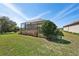 Beautiful backyard with a screened-in patio and lush green landscaping at 10802 Seasons Way, Palmetto, FL 34221