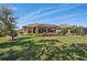 Expansive backyard featuring lush green grass, screened lanai, and mature landscaping, perfect for outdoor enjoyment at 10802 Seasons Way, Palmetto, FL 34221