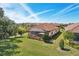 Landscaped backyard with a screened lanai, open patio with a firepit, and mature trees offering a private outdoor living space at 10802 Seasons Way, Palmetto, FL 34221