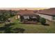 A screened lanai that opens to a lush yard, creating an ideal outdoor living space at 10802 Seasons Way, Palmetto, FL 34221