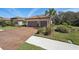 Charming house featuring a clay tile roof, two-car garage, and a paver driveway at 10802 Seasons Way, Palmetto, FL 34221