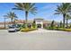 Community clubhouse exterior showcasing well-maintained landscaping, a decorative entrance, and ample parking for residents at 10802 Seasons Way, Palmetto, FL 34221