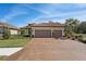 Beautiful single-story home featuring a clay tile roof, two-car garage and paver driveway at 10802 Seasons Way, Palmetto, FL 34221