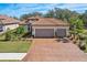 Charming home featuring a well-manicured lawn, a spacious driveway, and a neatly landscaped front yard at 10802 Seasons Way, Palmetto, FL 34221