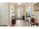 Bright foyer featuring a decorative glass front door, wood floors, and white trim at 10802 Seasons Way, Palmetto, FL 34221