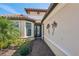 View of front door with glass paneling and palm tree wall decorations at 10802 Seasons Way, Palmetto, FL 34221