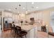 Well-equipped kitchen with a large island, stainless appliances, tile backsplash, and an abundance of cabinet space at 10802 Seasons Way, Palmetto, FL 34221