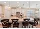 Open kitchen with granite countertops, stainless steel appliances, pendant lighting, and a large center island with bar seating at 10802 Seasons Way, Palmetto, FL 34221