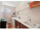Functional laundry room with white appliances, ample counter space, and shelving for storage at 10802 Seasons Way, Palmetto, FL 34221