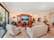 Spacious living room with hardwood floors, large TV, and sliding glass doors at 10802 Seasons Way, Palmetto, FL 34221